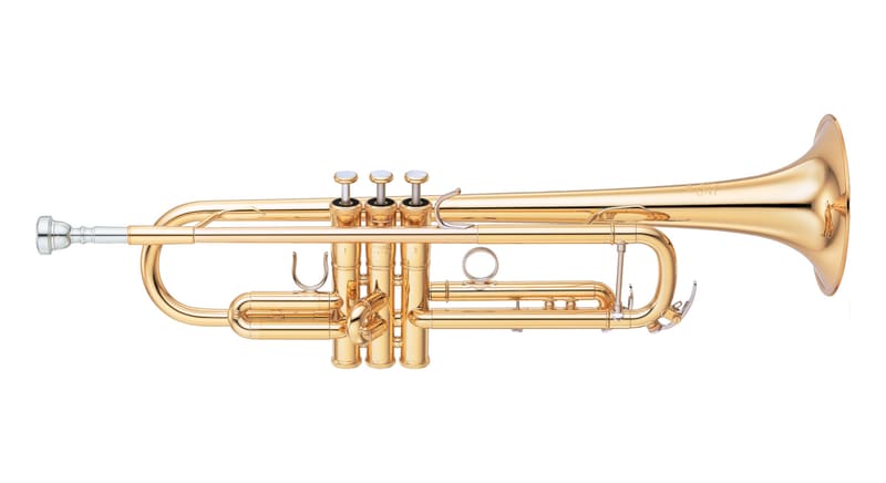 A gold-lacquered B-flat trumpet with three piston valves, a silver mouthpiece and a wide flared bell, shown in side view on a white background.